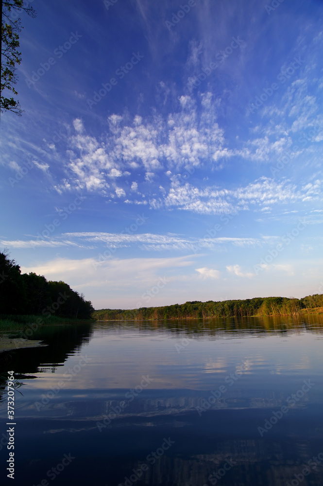 Fototapeta premium lake and blue sky with clouds in the morning
