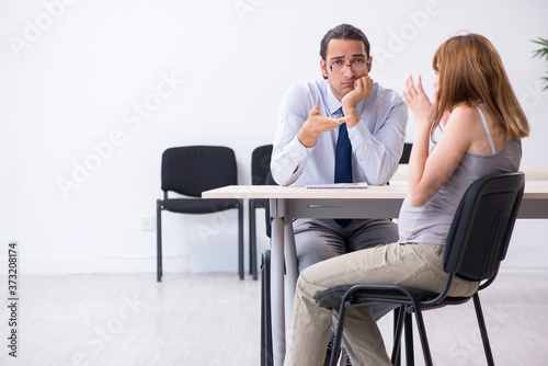 Pregnant woman visiting male psychologist doctor