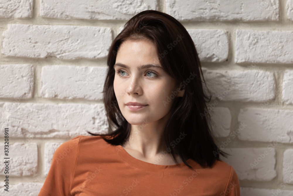 Pensive young Caucasian woman isolated on white brick wall background look in distance thinking planning, thoughtful dreamy millennial girl lost in thoughts, visualize imagine, plan bright future Pensive young Caucasian woman isolated on white brick wall background look in distance thinking planning, thoughtful dreamy millennial girl lost in thoughts, visualize imagine, plan bright future