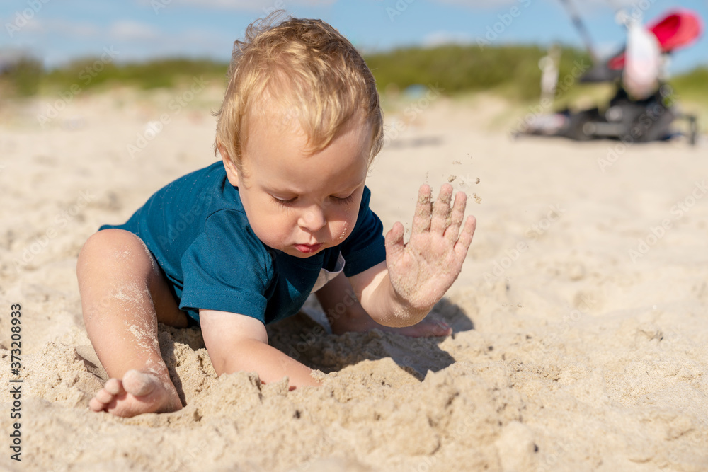 Little boy playing in the sandy Baltic sea beach. Family vacation in native resort. Little boy playing in the sandy Baltic sea beach. Family vacation in native resort.