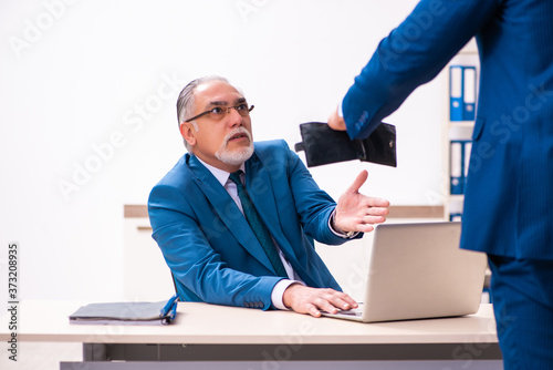 Male employee and cop in police investigation concept photo