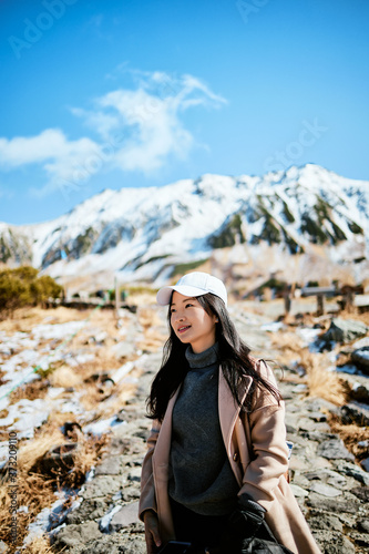 Asian woman is travelling in park that is named Murodo at Tateyma-Kurobe alpine route, Toyama, Japan