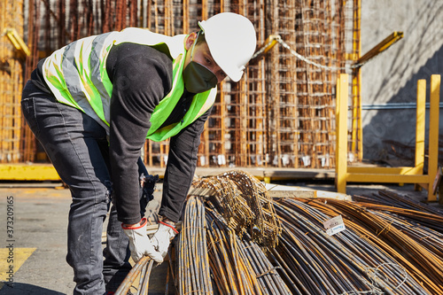 young man with mask and helmet in the middle of his job as a construction tool salesman