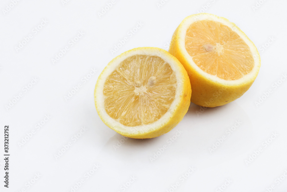 Two slices of lemon on top of white plastic acrylic Two slices of lemon on top of white plastic acrylic