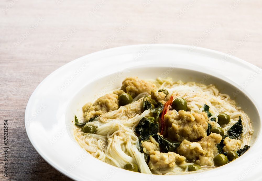 Thai rice noodles with green curry in plate, Thai street food Thai rice noodles with green curry in plate, Thai street food