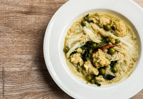 Thai rice noodles with green curry in plate, Thai street food