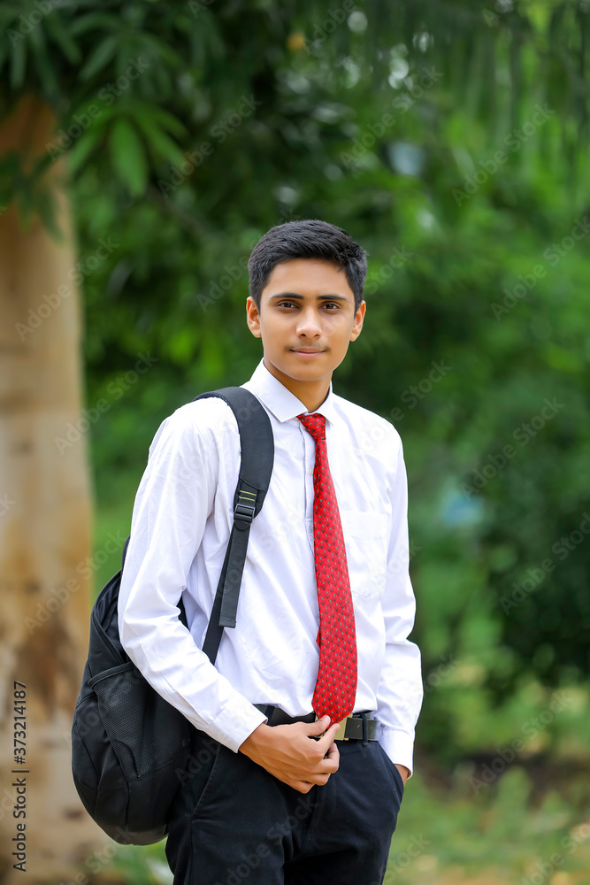 handsome Indian young boy wearing white shirt and red tie handsome Indian young boy wearing white shirt and red tie
