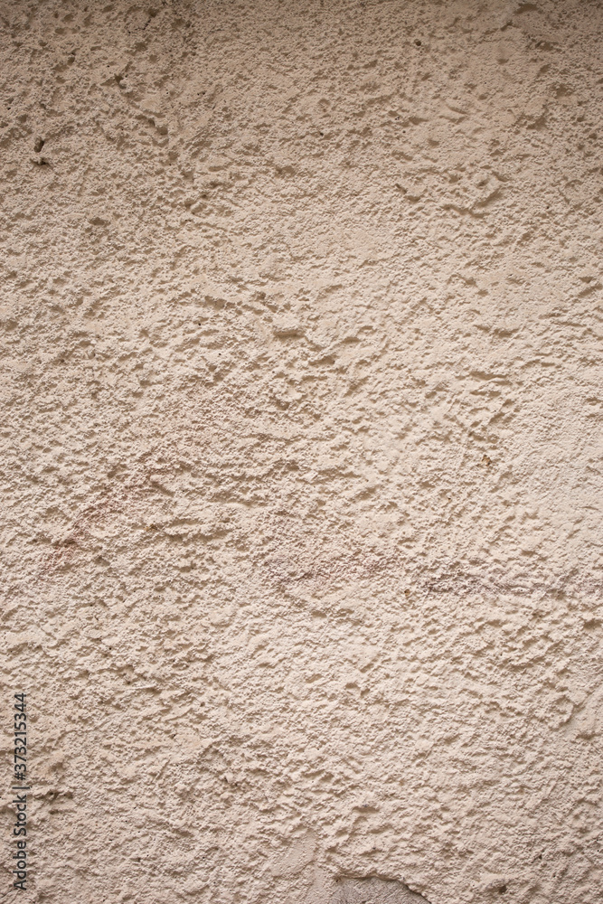 beige textured wall made of cement and sand. natural background for design beige textured wall made of cement and sand. natural background for design