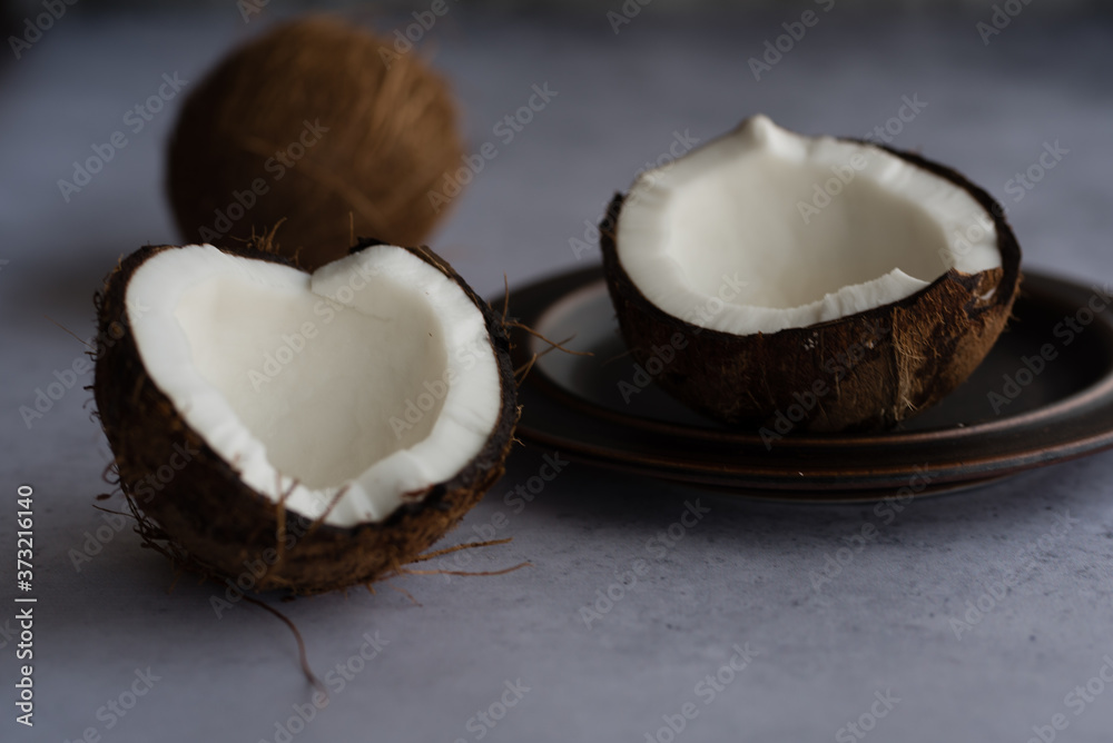 Cracked coconut arranged on textured background. Cracked coconut arranged on textured background.
