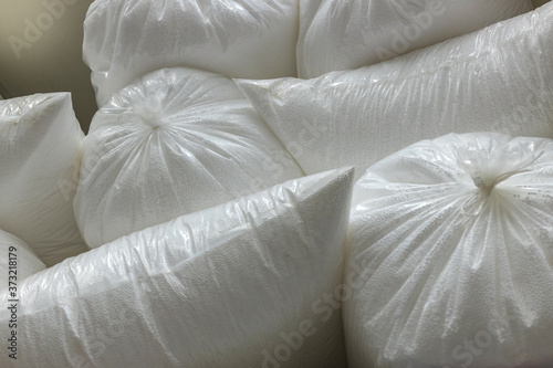 Bags with polystyrene beads at a building materials warehouse in a store. The insulation is in the distribution warehouse.