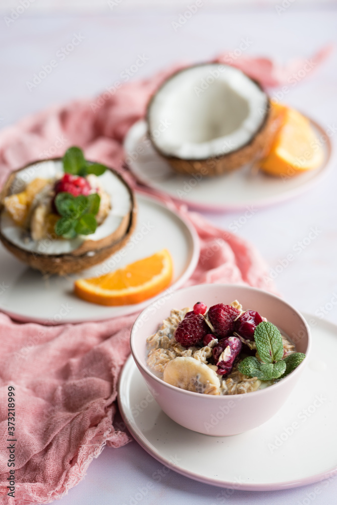 Overhead view of oatmeal with chia seed, .raspberries, bananas and oranges Overhead view of oatmeal with chia seed, .raspberries, bananas and oranges