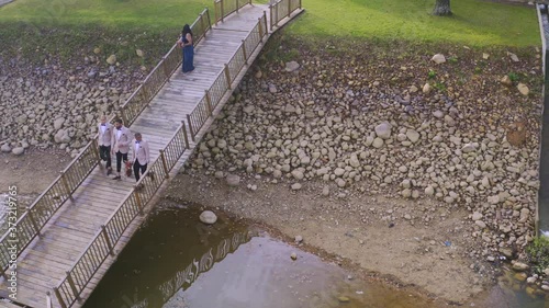 Groomsmen walking down pier onto lake