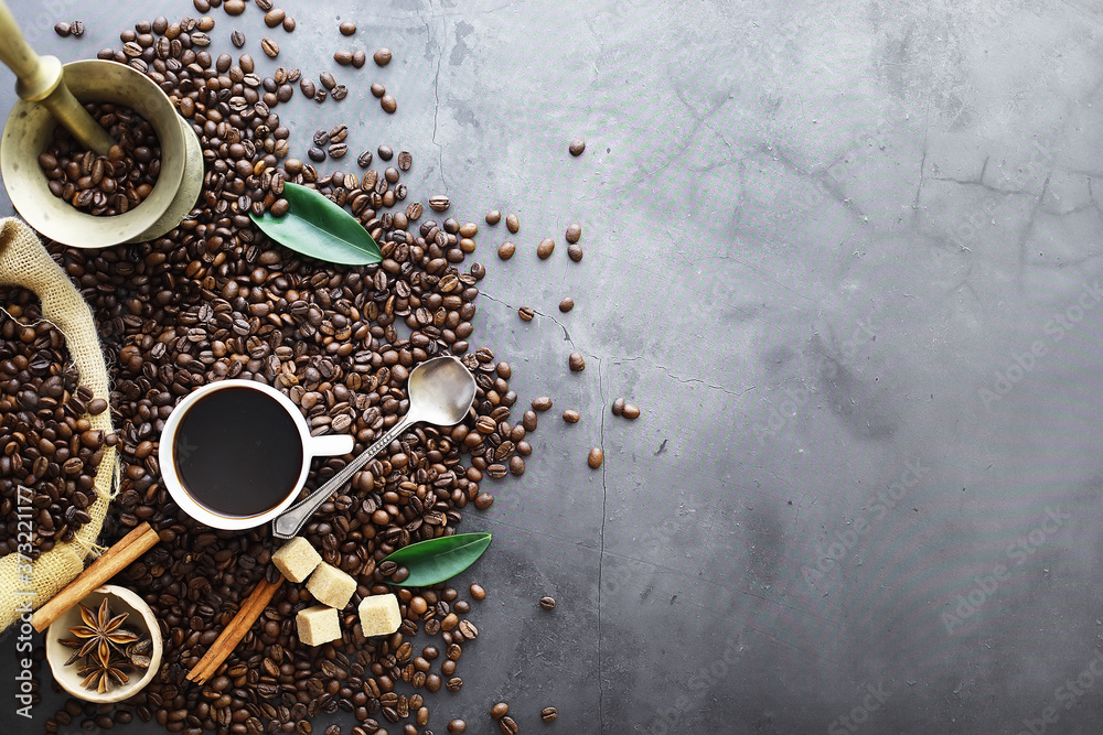 Bag of coffee. Coffee beans roasted on the table. Coffee beans with green leaves for cooking. Bag of coffee. Coffee beans roasted on the table. Coffee beans with green leaves for cooking.
