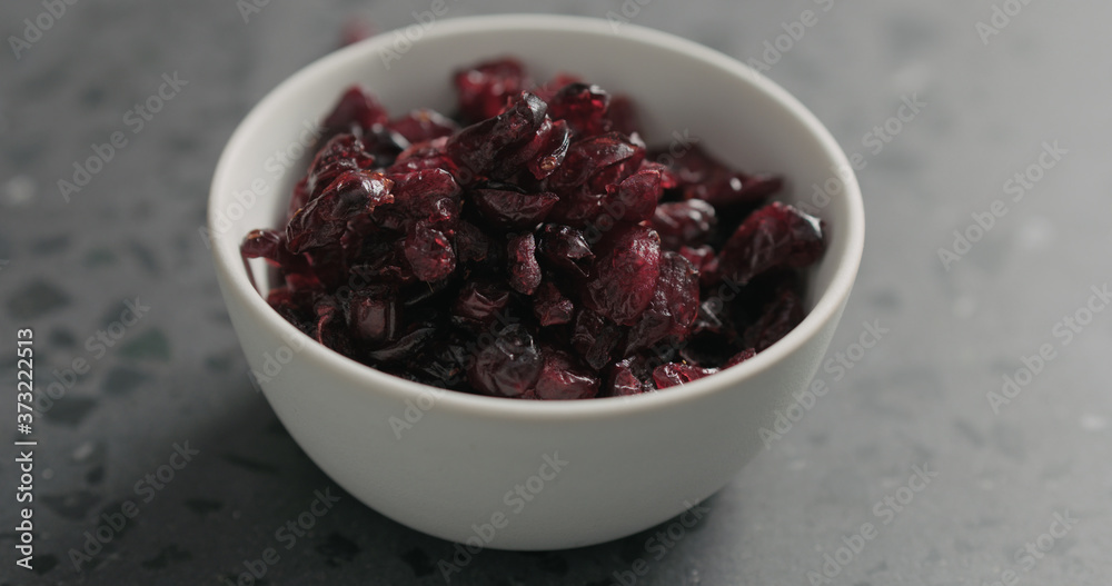 closeup dried cranberry in white bowl on terrazzo countertop closeup dried cranberry in white bowl on terrazzo countertop