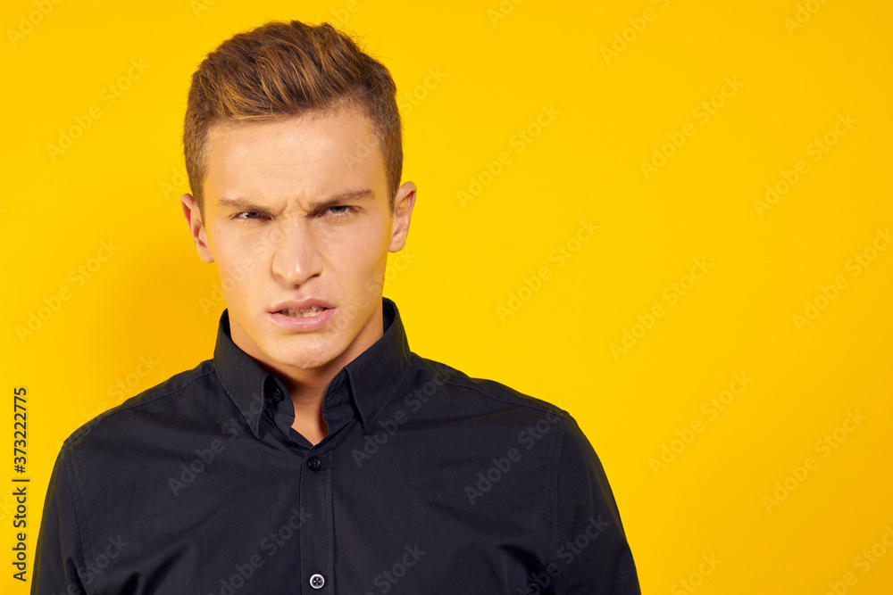 emotional man in black shirt lifestyle yellow isolated background