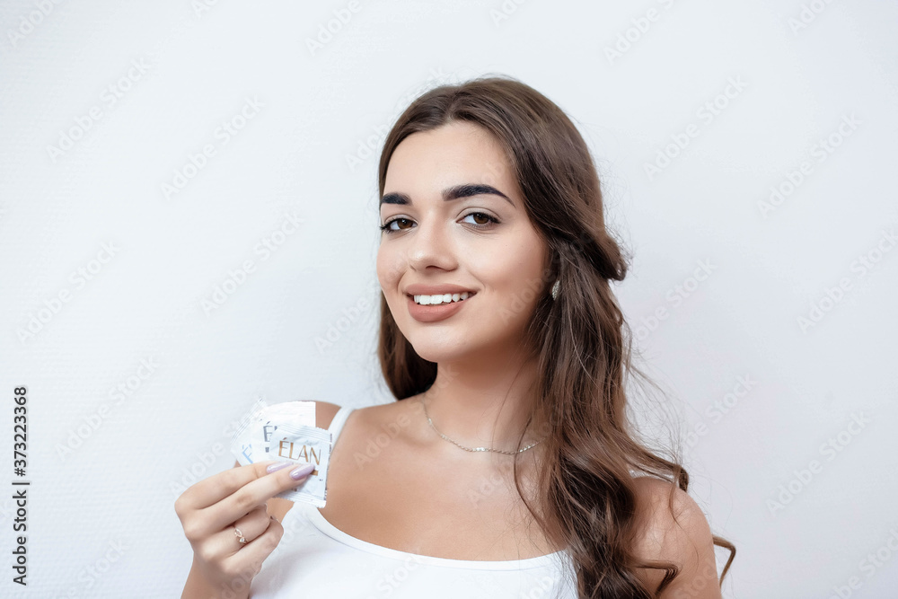 Portrait of a girl with makeup on a white wall. Beautiful girl on a white background. Portrait. Makeup. Portrait of a girl with makeup on a white wall. Beautiful girl on a white background. Portrait. Makeup.