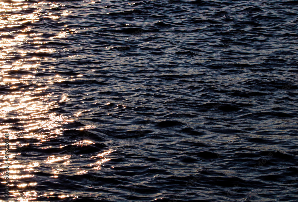 Tranquil and shiny water texture in a summer river, sea, ocean or swimming pool. Tranquil and shiny water texture in a summer river, sea, ocean or swimming pool.