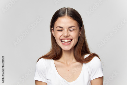 Happy woman on isolated background with closed eyes laughing 