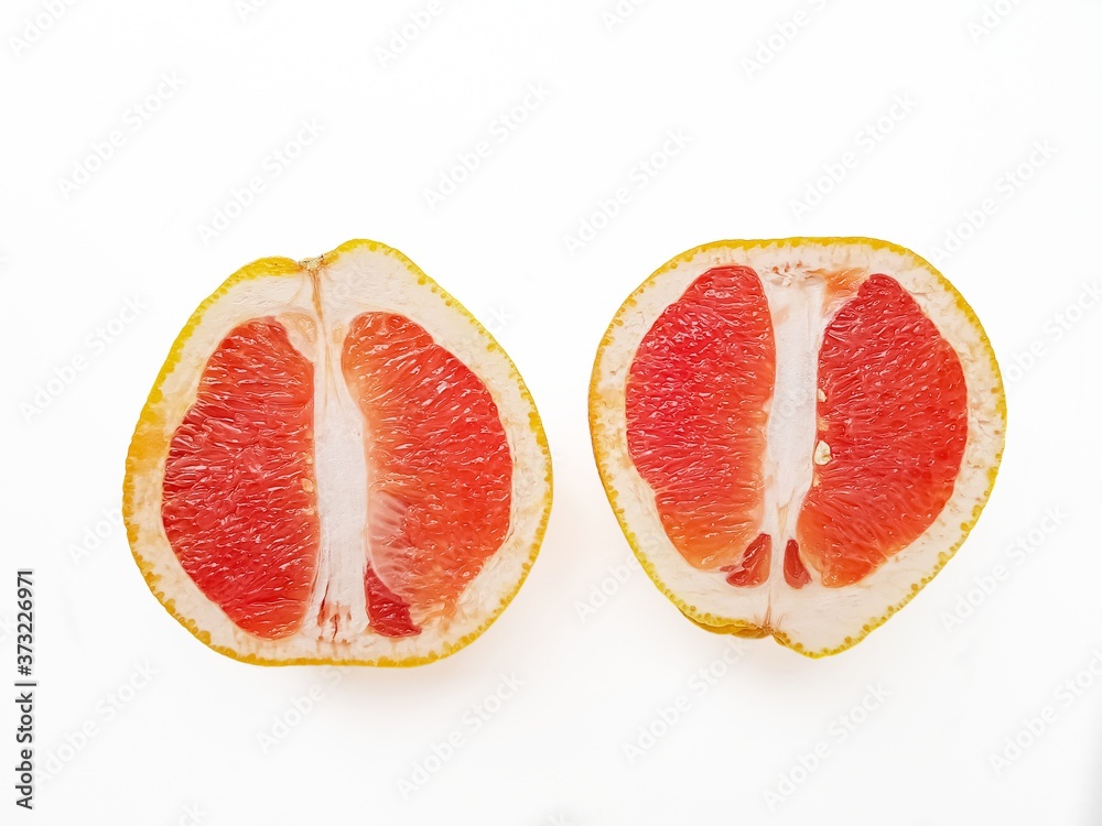 Red ripe juicy grapefruit in a cut on a white background. The concept of diet and healthy eating. A place for text. 
