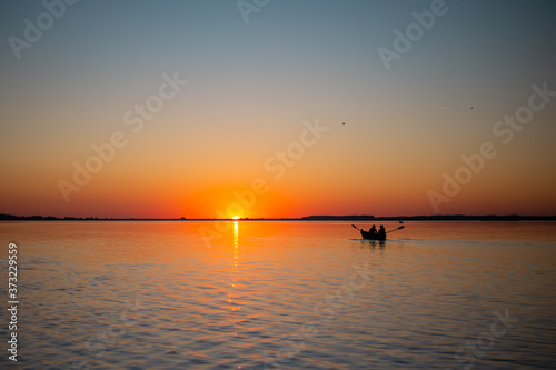 Sunset water lake golden hour reflection boats calm travel