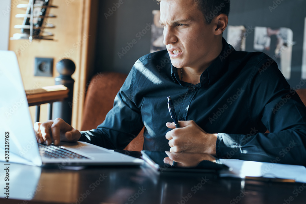 Business man freelancer with laptop in cafe at the table manager documents cup of coffee model