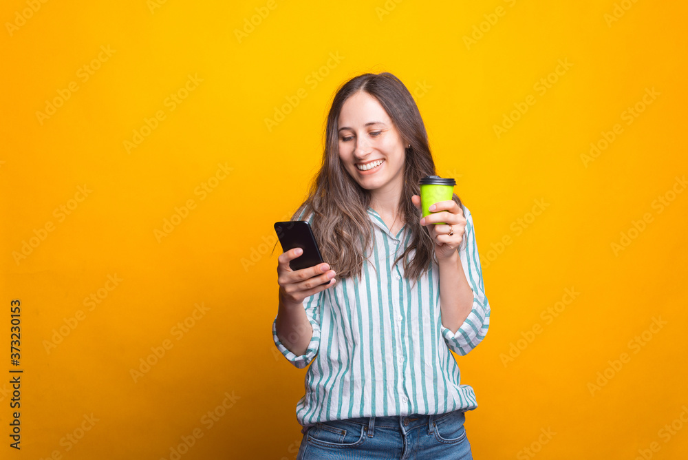 Photo of young happy woman using tablet and drinking cup of coffee. Photo of young happy woman using tablet and drinking cup of coffee.