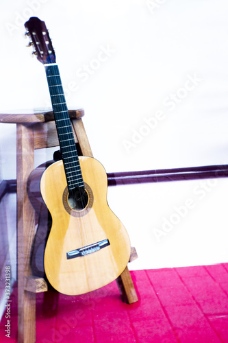 Spanish guitar musical instrument perched on a tripod