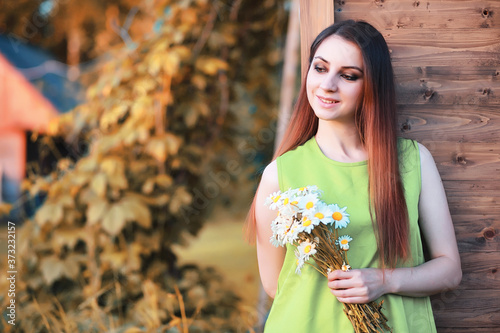 beautiful girl with a bouquet in autumn