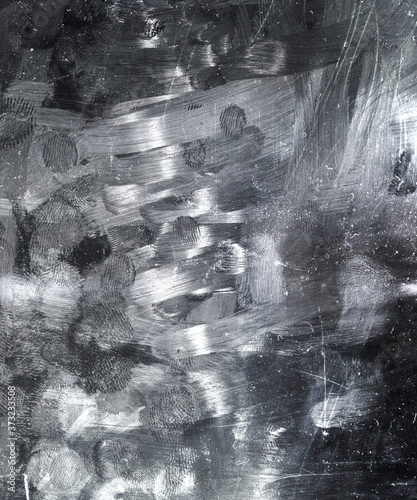 dirty tablet or smartphone display device surface with smudgy fingerprints and dust and scratches.
