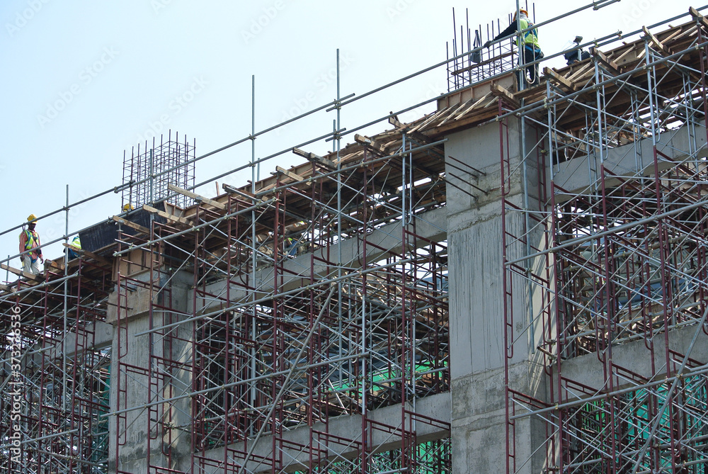 JOHOR, MALAYSIA -APRIL 13, 2016: Scaffolding used as the temporary structure to support platform, form work and structure at the construction site. Also used it as a walking platform for workers. 

