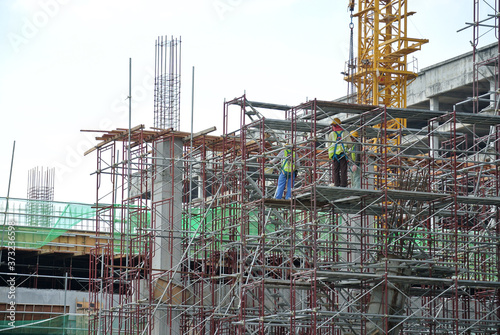 JOHOR, MALAYSIA -APRIL 13, 2016: Scaffolding used as the temporary structure to support platform, form work and structure at the construction site. Also used it as a walking platform for workers.   © Aisyaqilumar