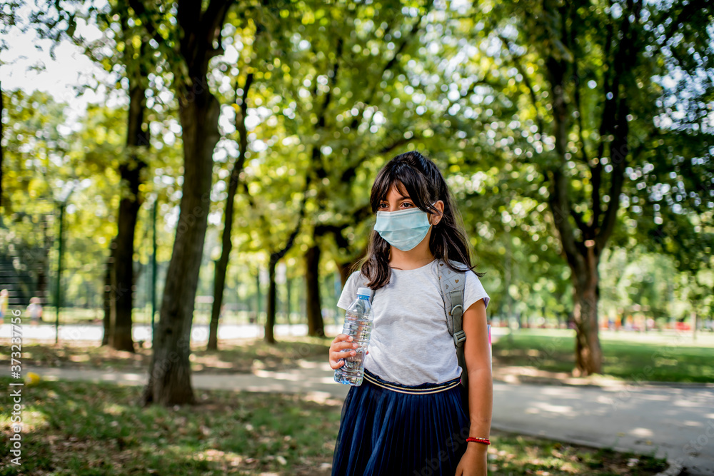 Portrait of girl going to school with protective face mask on. Portrait of girl going to school with protective face mask on.