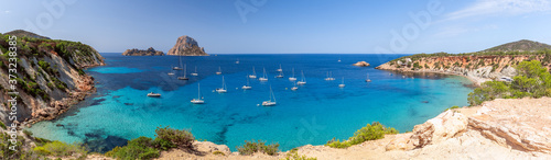 Hyper panorama of Cala Hort with sea sailing yachts and the mountain Es Vedra. Ibiza, Balearic Islands, Spain