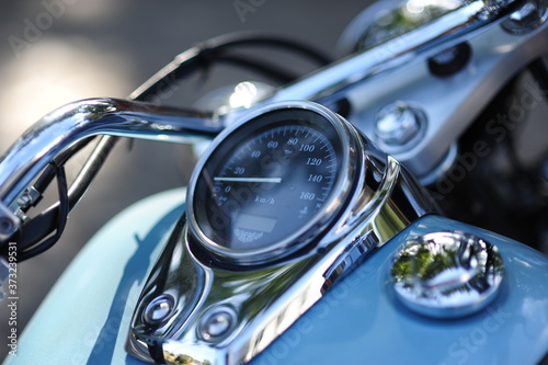 Motorcycle detail with gasoline tank and speedometer. Chrome motorcycle details closeup