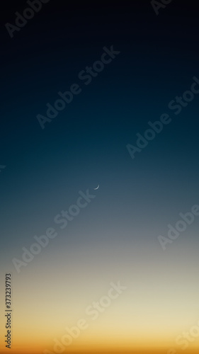 crescent moon in the turquoise sky and amazing sunset