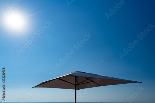 bottom view. beach umbrella against blue sky.
