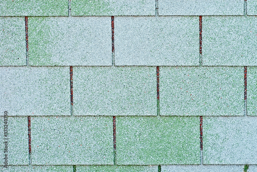 Obraz premium Flexible tile is made of fiberglass impregnated with bitumen. Green roof texture close up.