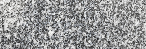 Granite texture. Natural granite with a grainy pattern. Stone background. Solid rough surface of rock. Durable construction and decoration material. Close-up. © Andrei Stepanov