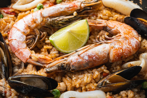 Traditional spanish seafood paella in pan on white background