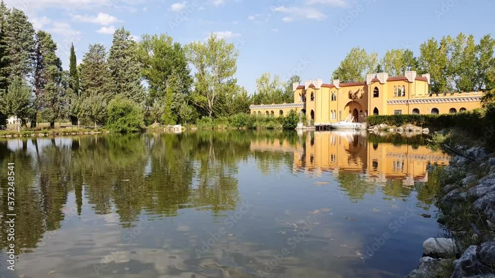 View of an italian small lake with a beautiful building in the background. View of an italian small lake with a beautiful building in the background.