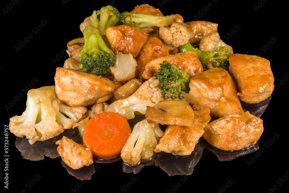 Delicious chicken pieces with fresh vegetables with reflection Delicious chicken pieces with fresh vegetables with reflection