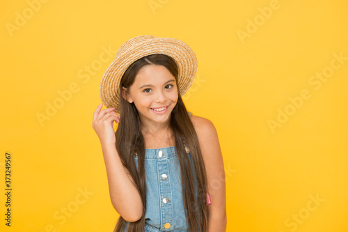 Enjoying vacation. Good vibes. Beach style. Little beauty in straw hat. Portrait of happy cheerful girl in summer hat yellow background. Fancy outfit. Teen girl summer fashion. Summer holidays