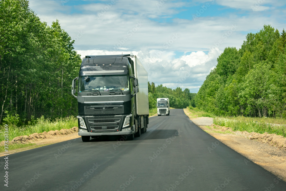 Truck on the road with a wagon full of cargo. Truck on the road with a wagon full of cargo.