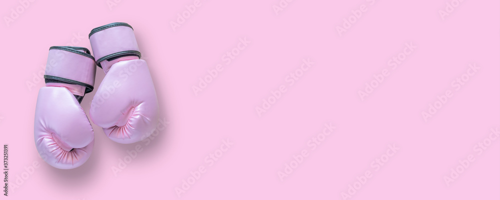 Breast cancer awareness concept with pink boxing gloves isolated (clipping path) for girl and woman fight with illness on pink background with copy space - obrazy, fototapety, plakaty 