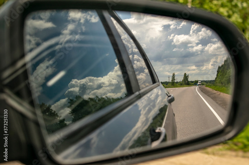 Reflection of the road in the car mirror. © Ilia Petukhov