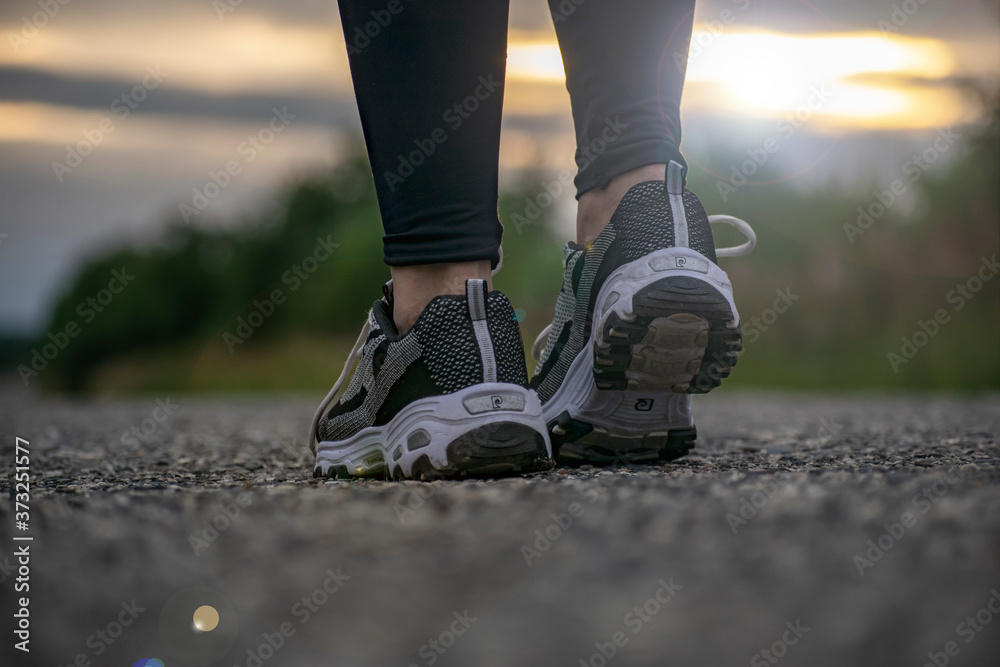 Sports girl in sneakers training outdoors. Sports girl in sneakers training outdoors.