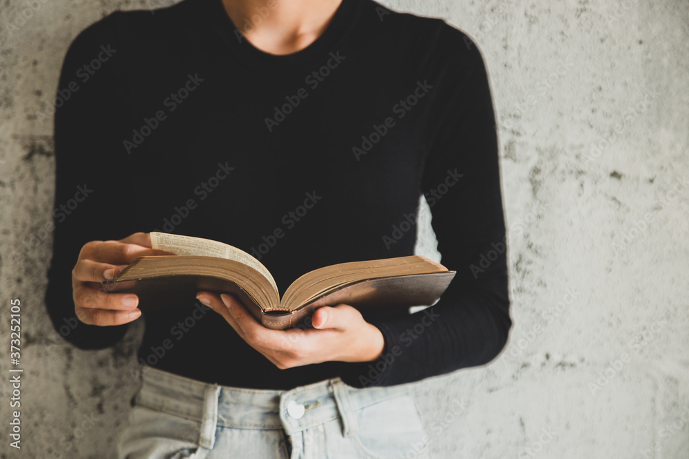 Fototapeta premium Woman holding the bible in hands, Concept for faith, spirituality and religion