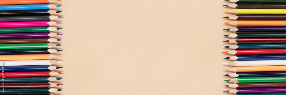 Frame made of colorful pencils on a beige background. Banner with back to school concept. Frame made of colorful pencils on a beige background. Banner with back to school concept.