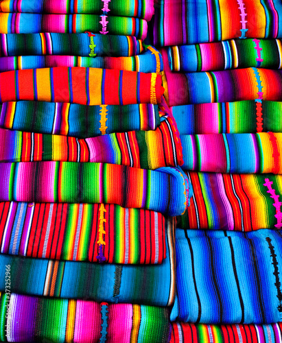 Traditional textiles of different bright colors and patternsfor sale on the indigenous market, Antigua Guatemala
