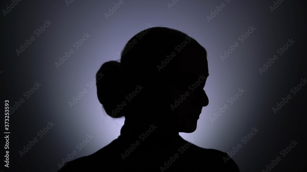 Silhouette of woman posing at the camera
